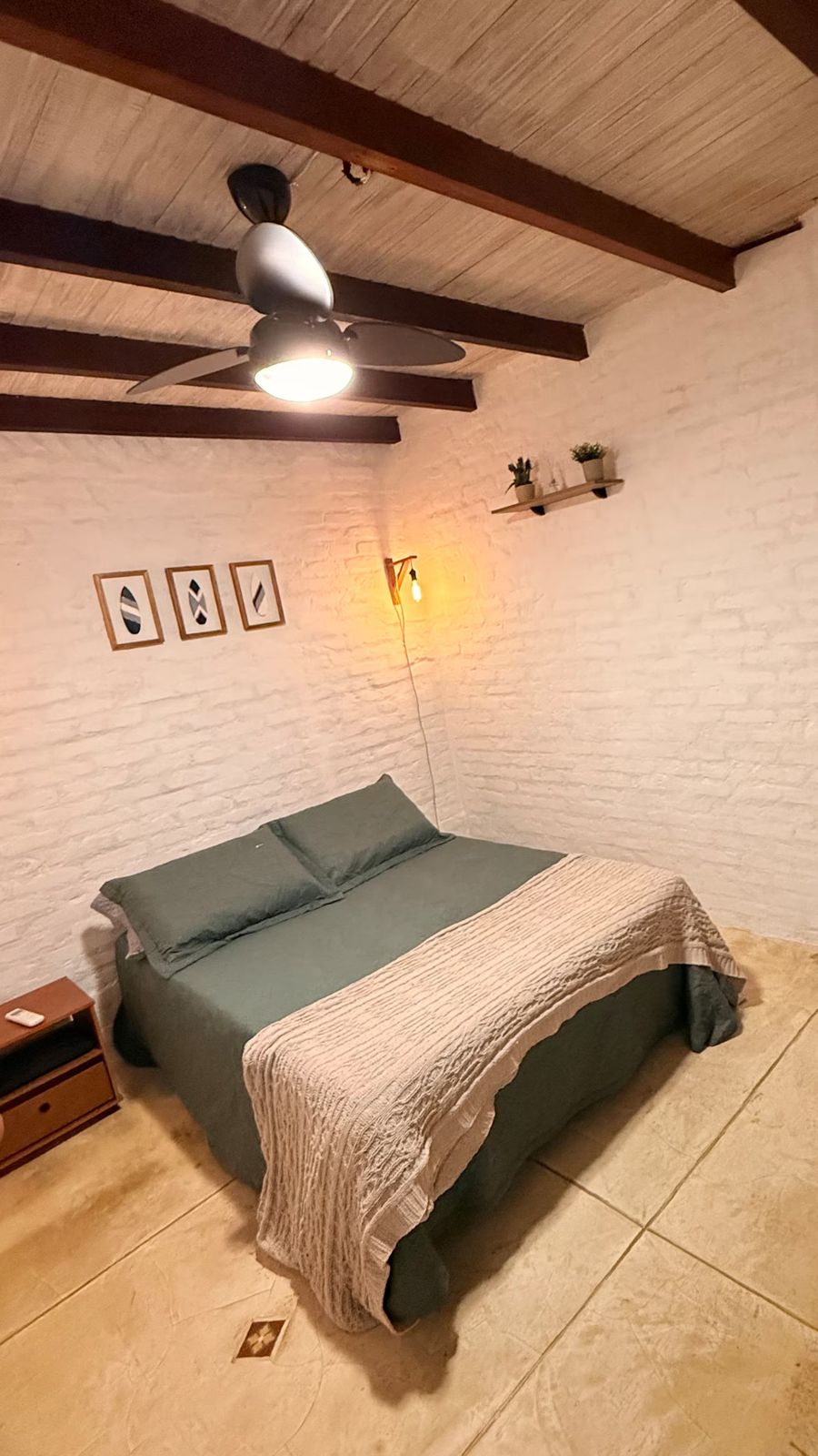 Cama de casal com quadros na parede